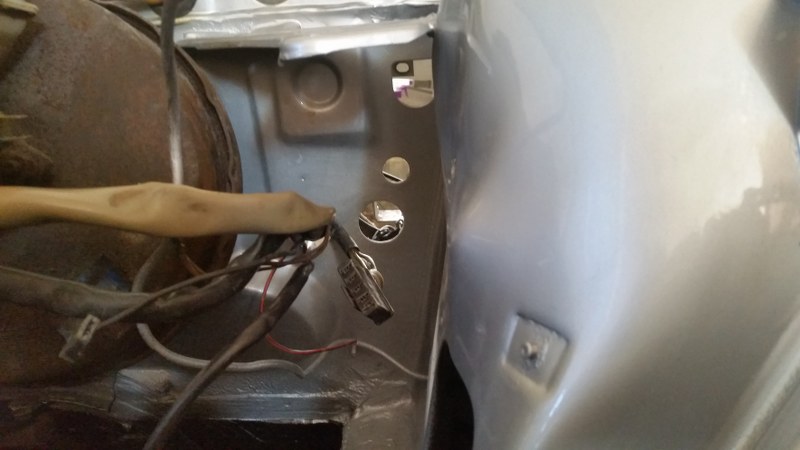 Behind battery compartment